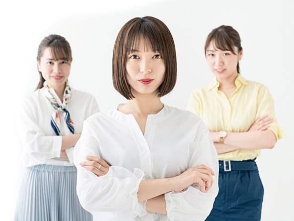 Three east Asian women standing with their arms crossed